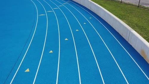 Aerial View of Bright Blue Curved Running Track