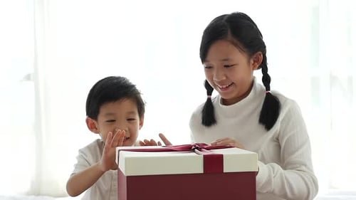 Excited Children Opening Magical Gift Box Together