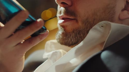 Man Speaking Into Smartphone in Urban Setting