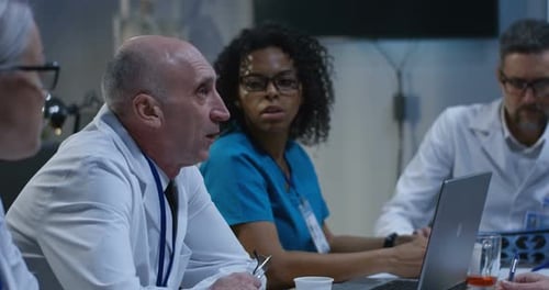 Doctors and Colleagues Meeting in Workplace Setting