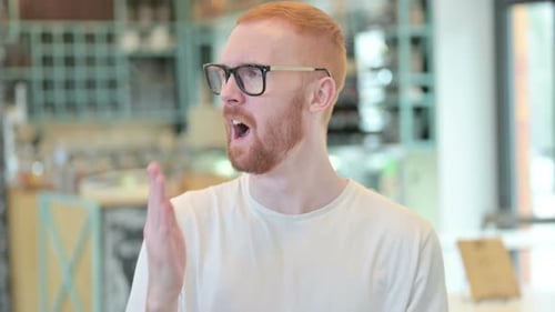 Portrait of Sleepy Redhead Man Yawning