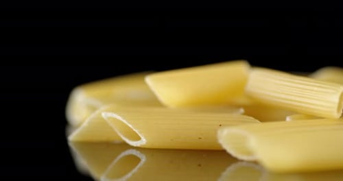 Penne Pasta Close Up on Reflective Surface