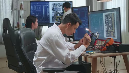 Scientists Working on Computers and Circuit Boards