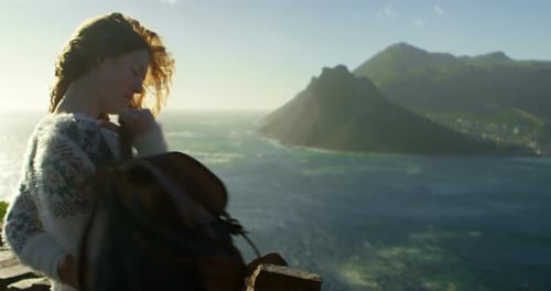 Woman standing with backpack near a sea 4k