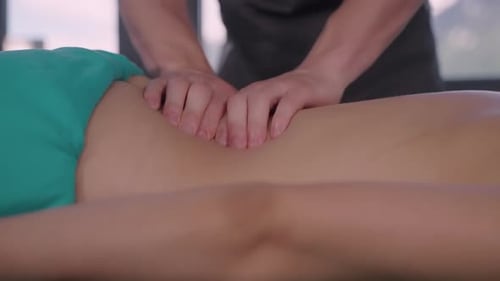 Medical Massage in Modern Manual Therapy Clinic Masseur is Massaging Back of Patient