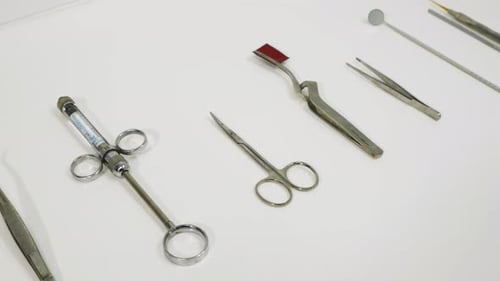 Medical Instruments Lined Up on White Table
