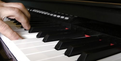 Close Up of Fingers Playing Piano Keys