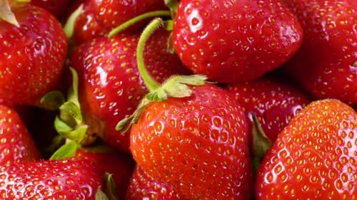 Slow Motion Rotation of Juicy Red Ripe Organic Strawberries