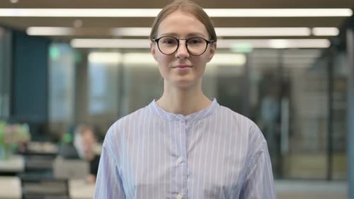 Woman in Glasses in Modern Workplace Environment