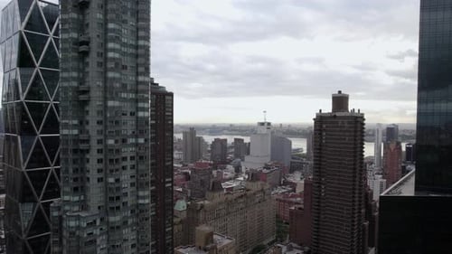 Aerial view flying in middle of high-rise in MIdtown, NYC, USA - reverse, drone shot