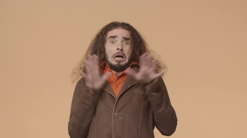 Scared Man with Long Hair Reacts in Fear