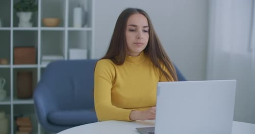 A Woman Sitting in the Office Warms Her Back. Posture and Back Problems While Working