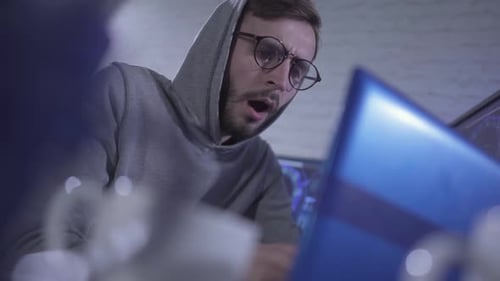 Young Adult Drinks Coffee while Working on Computer