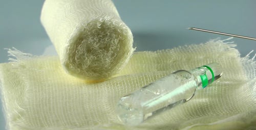 Medical Equipment Close Up: Vial, Gauze, and Syringe