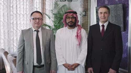 Three Men in Suits Standing Indoors