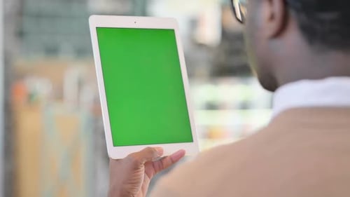 African American Man Using Tablet with Green Chroma Key Screen