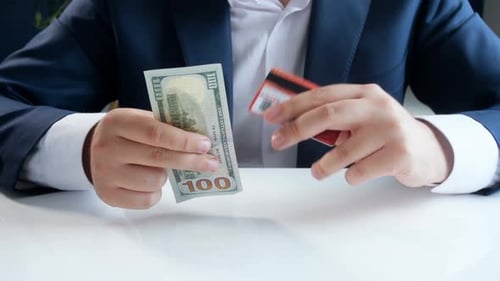 Hands With Cash And Credit Card On Desk
