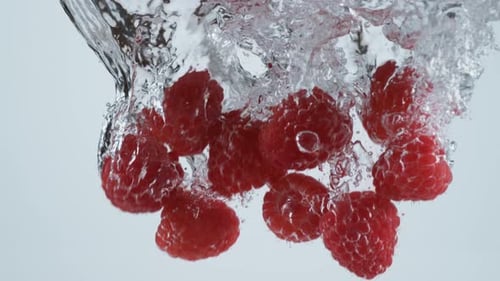 Slow motion shot of raspberries splashing into water, shot with Phantom Flex 4K camera.