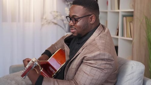 Man Plays Guitar Inside Apartment