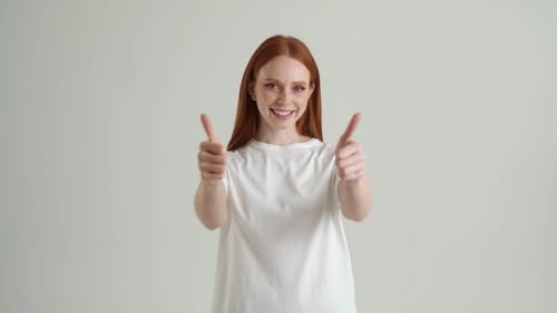 Smiling Redhead Giving Two Thumbs Up