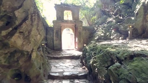 Motion Along Rocky Walls To Stone Arch Gate in Old Cave