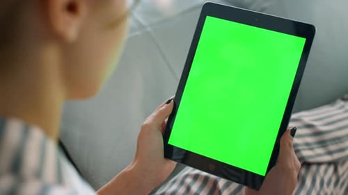 Woman Holds Tablet with Green Screen Indoors