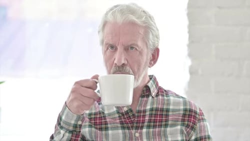 Portrait of Casual Old Man Drinking Coffee