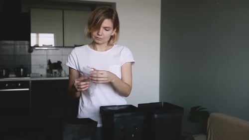 Woman Sorting Recyclable Trash at Home