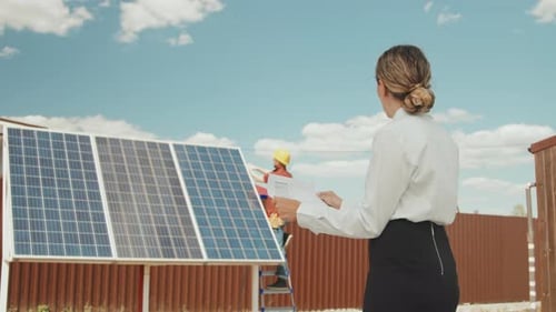 Woman Managing Installation of Solar Panels