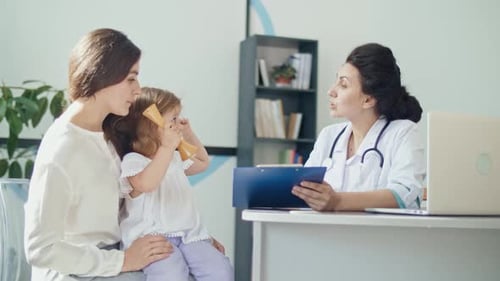 Mother and Child Visit Doctor in Office