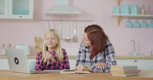 Young 30s Mother Helping Preteen Daughter with Online Schooling. School Girl Studying Online Staying