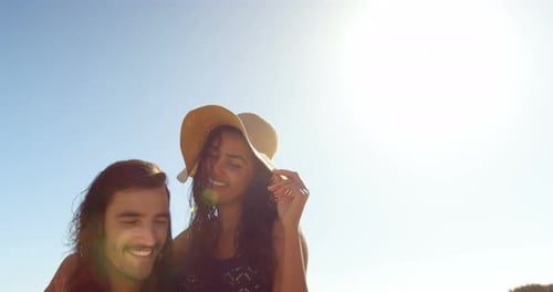 Couple using mobile phone on the beach 4k