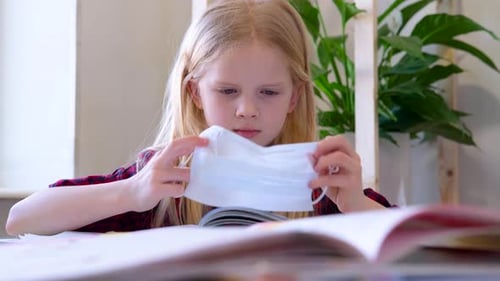 Child Puts On Mask and Reads Magazine