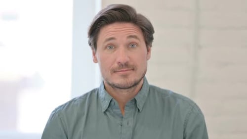 Man Looking at Camera Wearing Button-Down Shirt