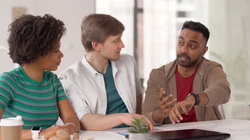 Man Showing Smart Watch To Coworkers at Office 31