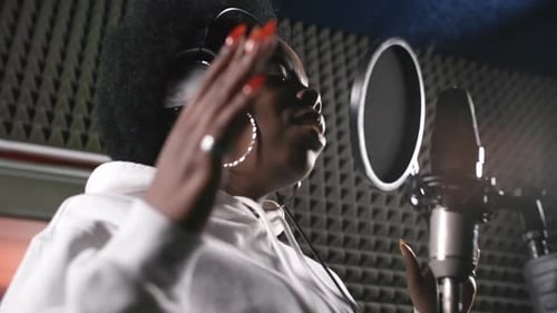 Female Musician Singing Song in Recording Studio