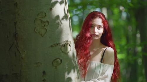 Red Haired Woman Posing Behind a Tree