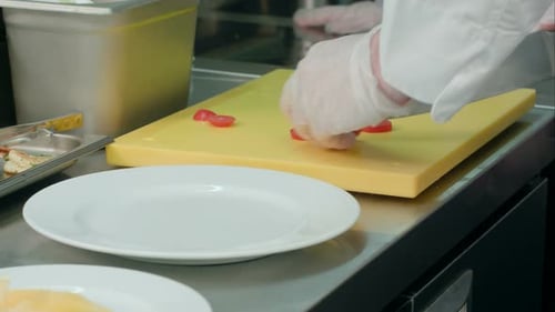 Chef Slicing Tomatoes in Commercial Kitchen