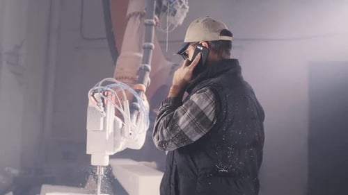 Craftsman Speaking on Smartphone in Workshop