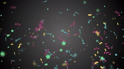 Buntes Konfetti fällt in Zeitlupe auf schwarzem Hintergrund