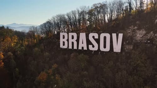 Brasov sign on the top of the hill near the city, yellowed trees, Romania
