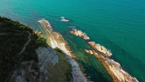 Top View of Rocky Coastline Down Blue Sea Deep White Cliffs
