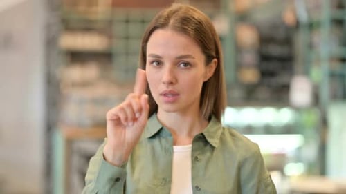 Young Woman Gesturing "No" Indoors