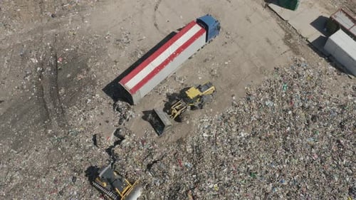 Heavy Equipment Bulldozers in Large Landfill Aerial Shot