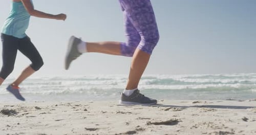 Senior women running on the beach
