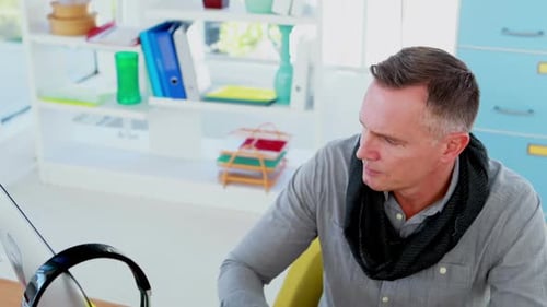 Man Working on a Drawing Tablet in Office