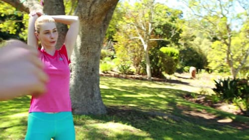 Women Stretch Together in Urban Park on Sunny Day