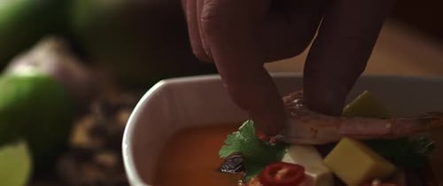 Video of chef decorating the dish with shrimp before serving.
