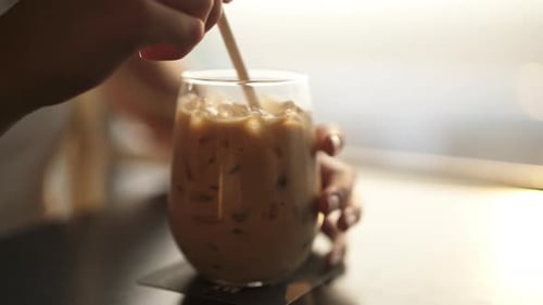 Refreshing Iced Coffee Drink Stirred with Straw