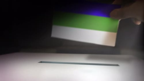 Hand Casting Vote with Flag into Ballot Box